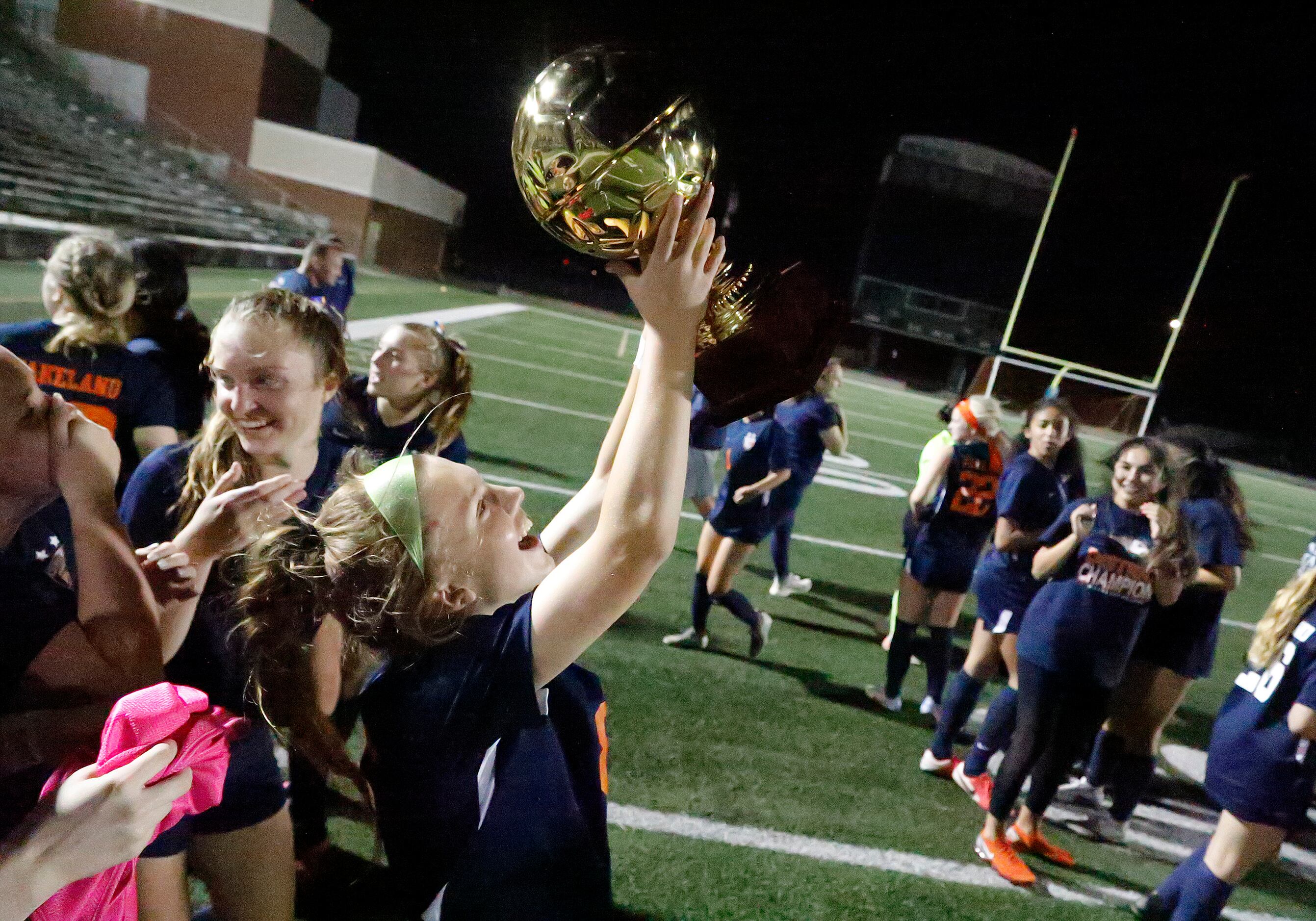 Wakeland forward Brooke Hartshorn (8) cherishes her chance to hold the trophy after Wakeland...