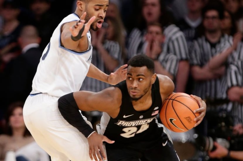 Villanova's Phil Booth (5) defends against Providence's Kyron Cartwright (24) during the...