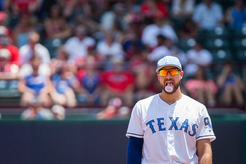 Texas Rangers first baseman Joey Gallo blows bubbles between pitches during the second...