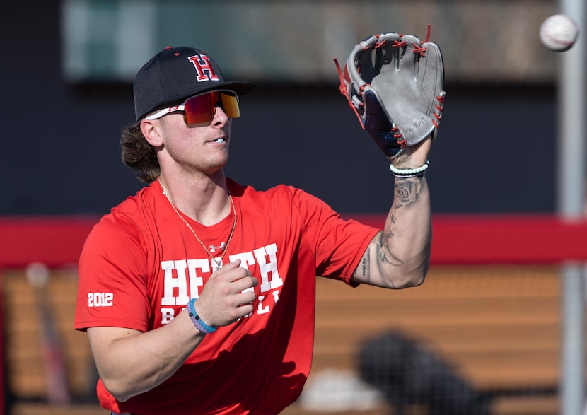 Rockwall-Heath High School senior shortstop, Jett Williams, catches a ball during warmups at...