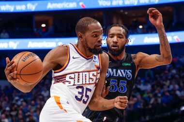 Phoenix Suns' Kevin Durant (35) dribbles past Dallas Mavericks forward Derrick Jones Jr....