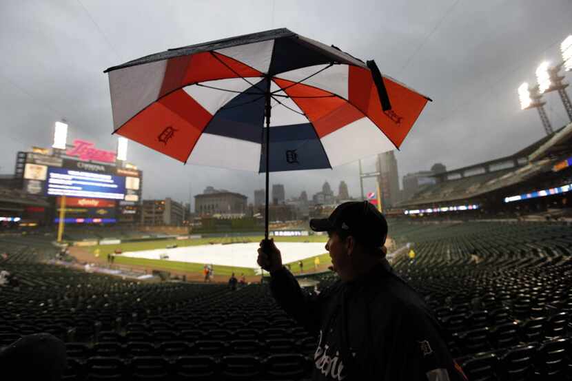 A fan leaves Comerica Park after the Detroit Tigers-Texas Rangers baseball game was...