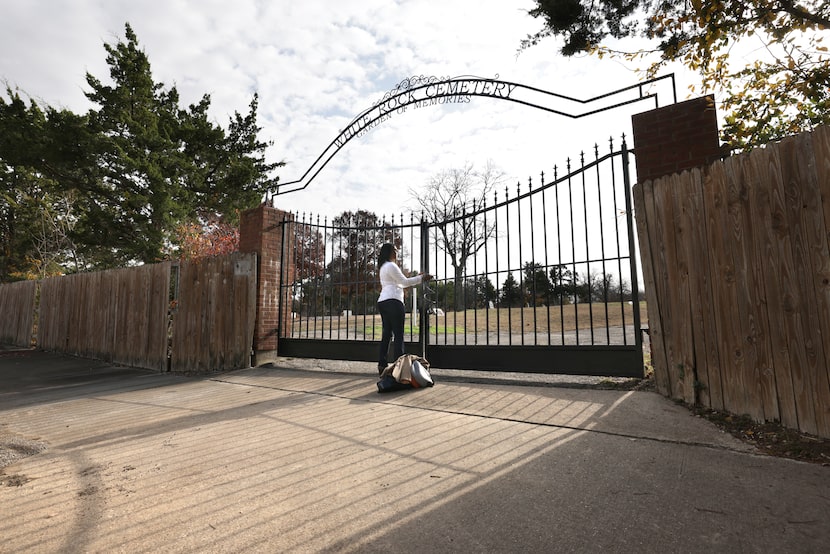 Sheniqua Cummings locks the gate of White Rock Cemetery Garden of Memories at the end of her...