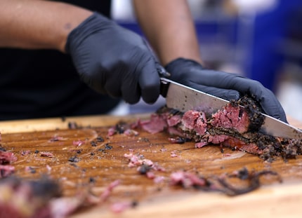 A cook chops pastrami for barbecue sandwiches at the State Fair of Texas.