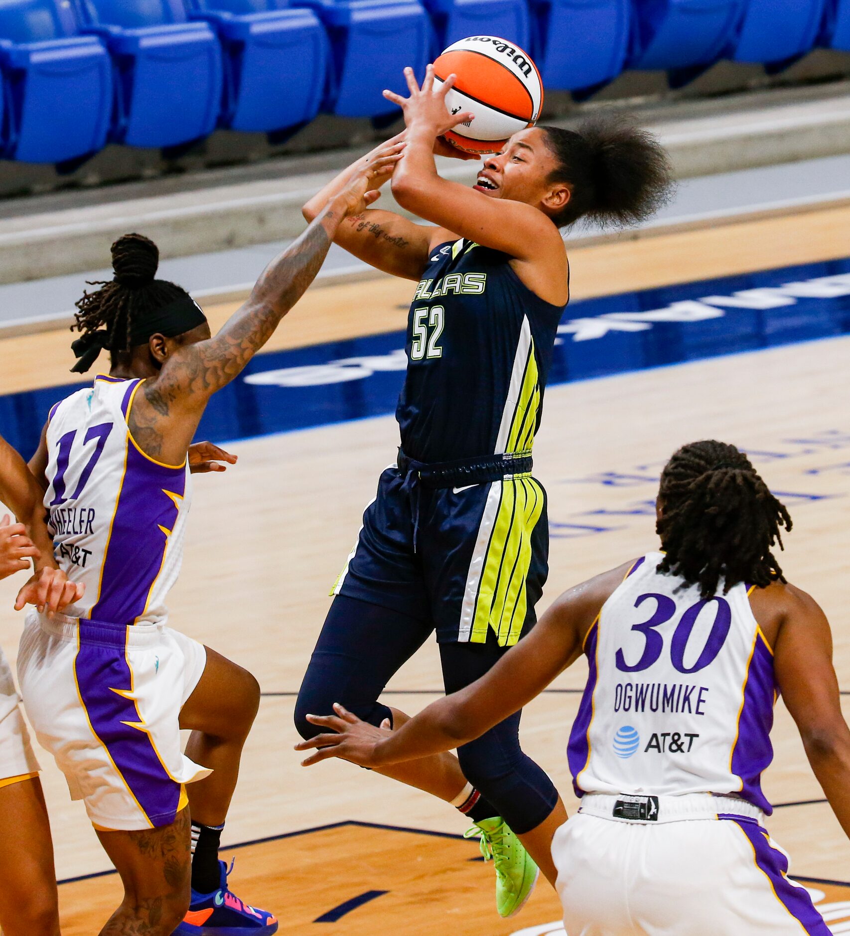 Los Angeles Sparks guard Erica Wheeler (17) touches Dallas Wings guard Tyasha Harris (52)...