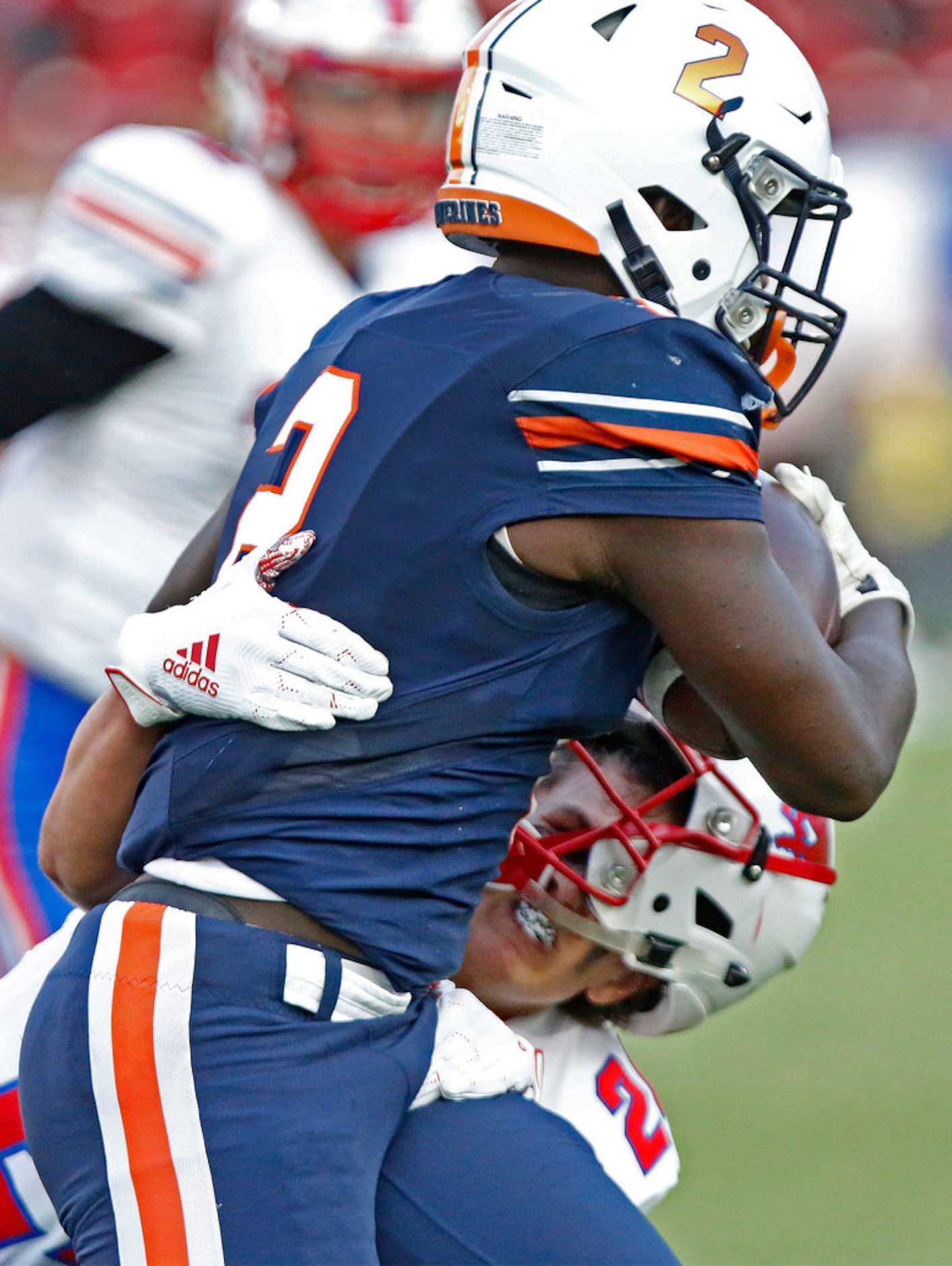 Richardson Pearce High School defensive back Jack Jones (24) looses his helmet to a stiff...