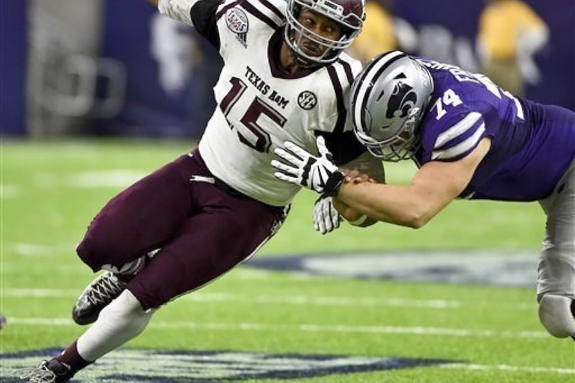 FILE - In this Dec. 28, 2016, file photo, Texas A&M's Myles Garrett (15) tries to get around...