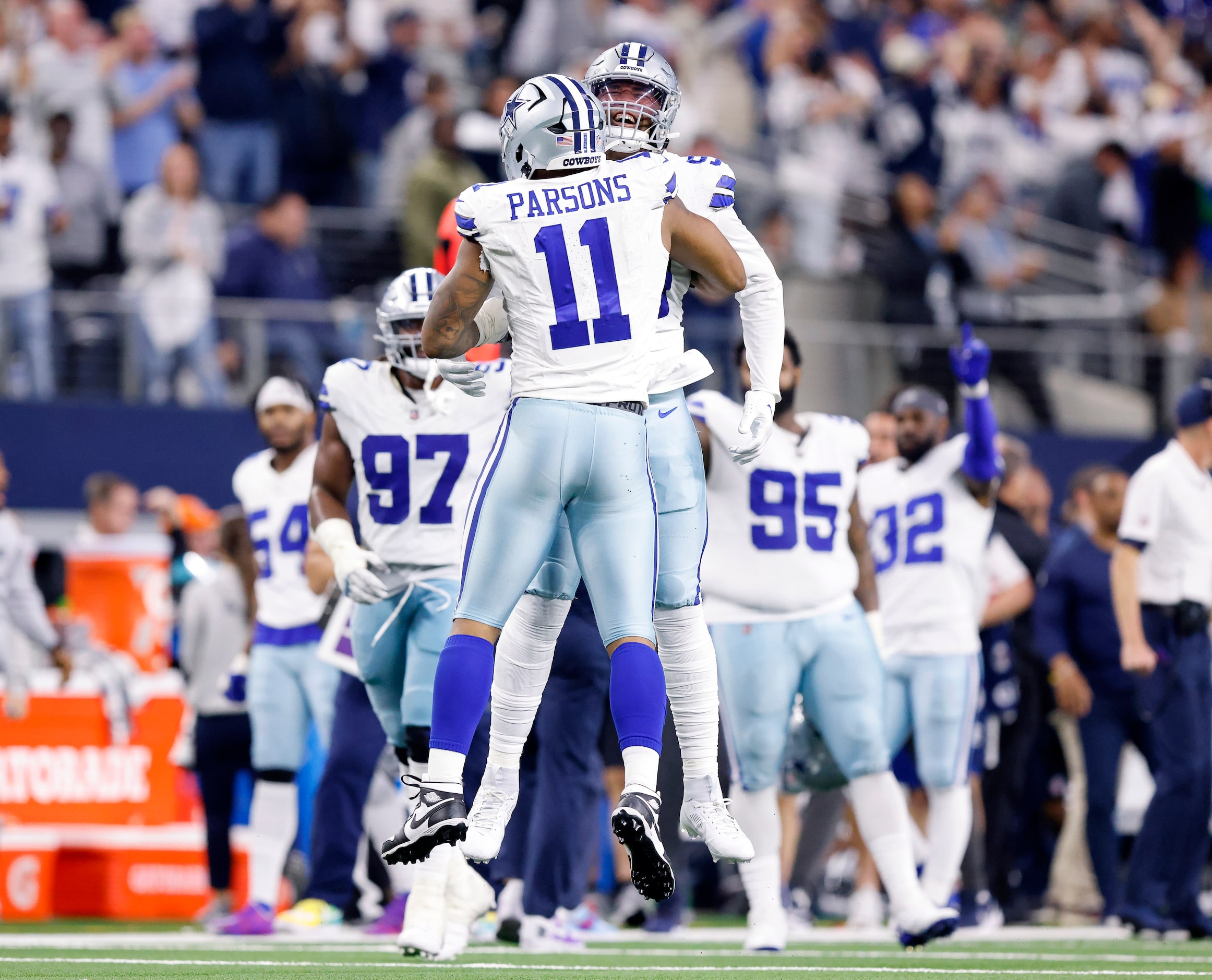 Dallas Cowboys defensive end Chauncey Golston (facing) congratulates linebacker Micah...