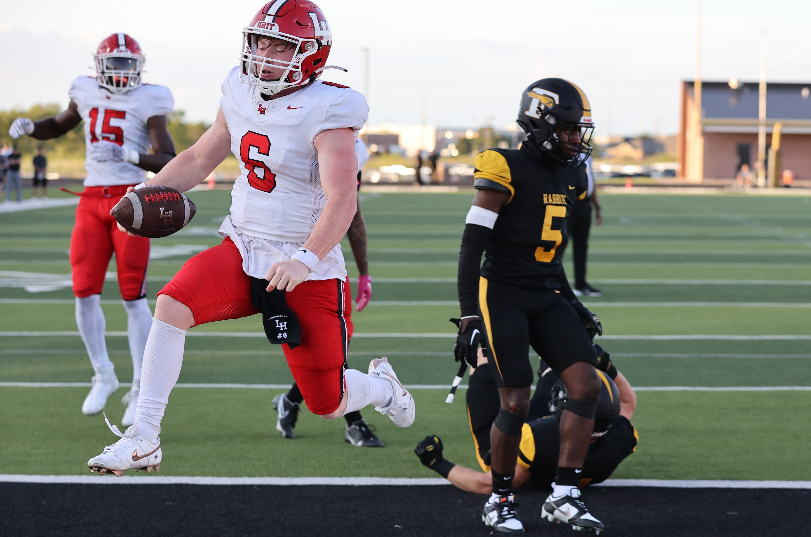 Lake Highlands QB Harrison Day (6) leaps into the endzone for a touchdown, as Forney...