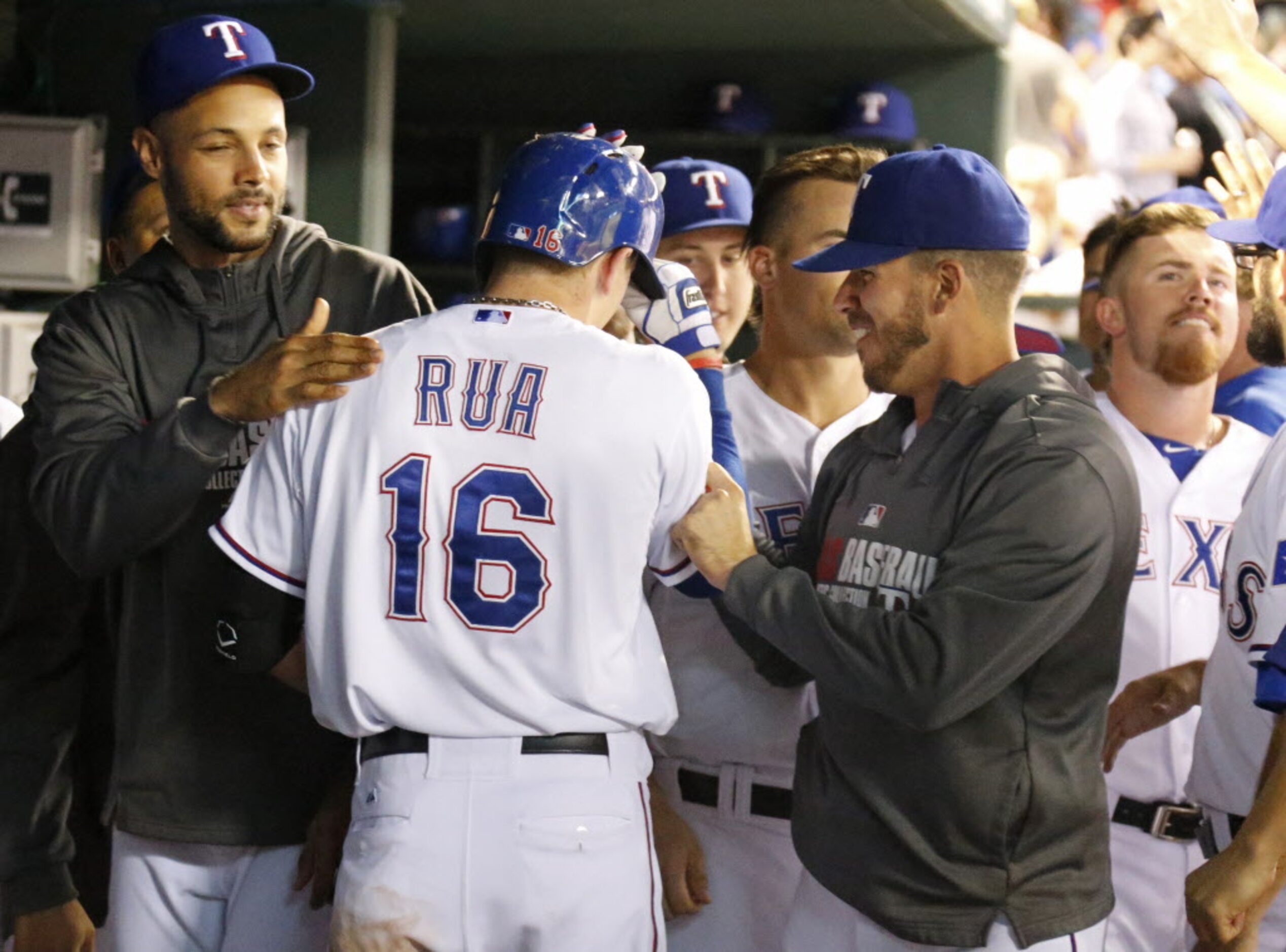 Teammates greet rookie Ryan Rua in the dugout after his three-run homer in the seventh...