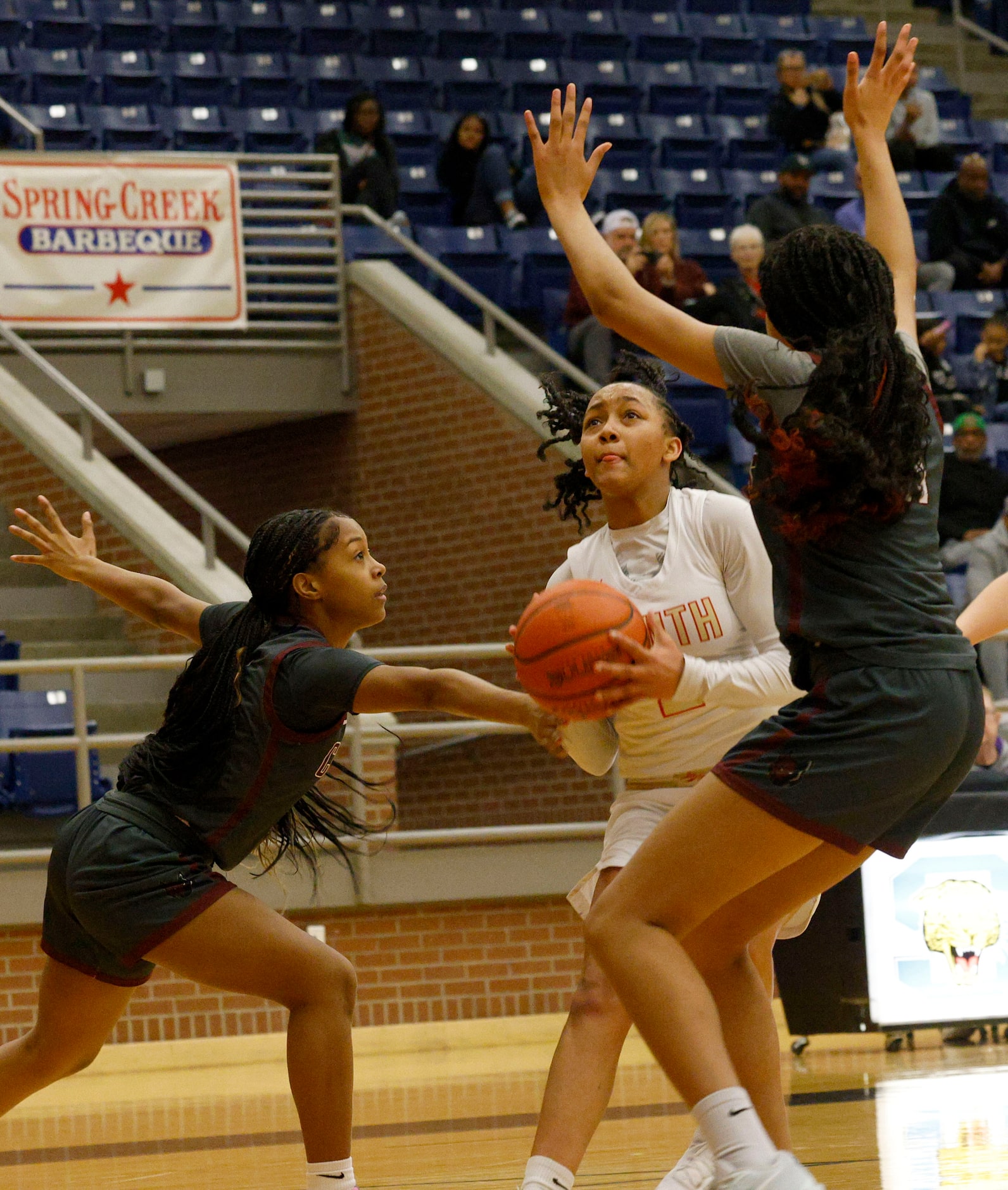 South Grand Prairie's Payton Garrett (2) tries to shoot against Frisco Heritage's Aniya...