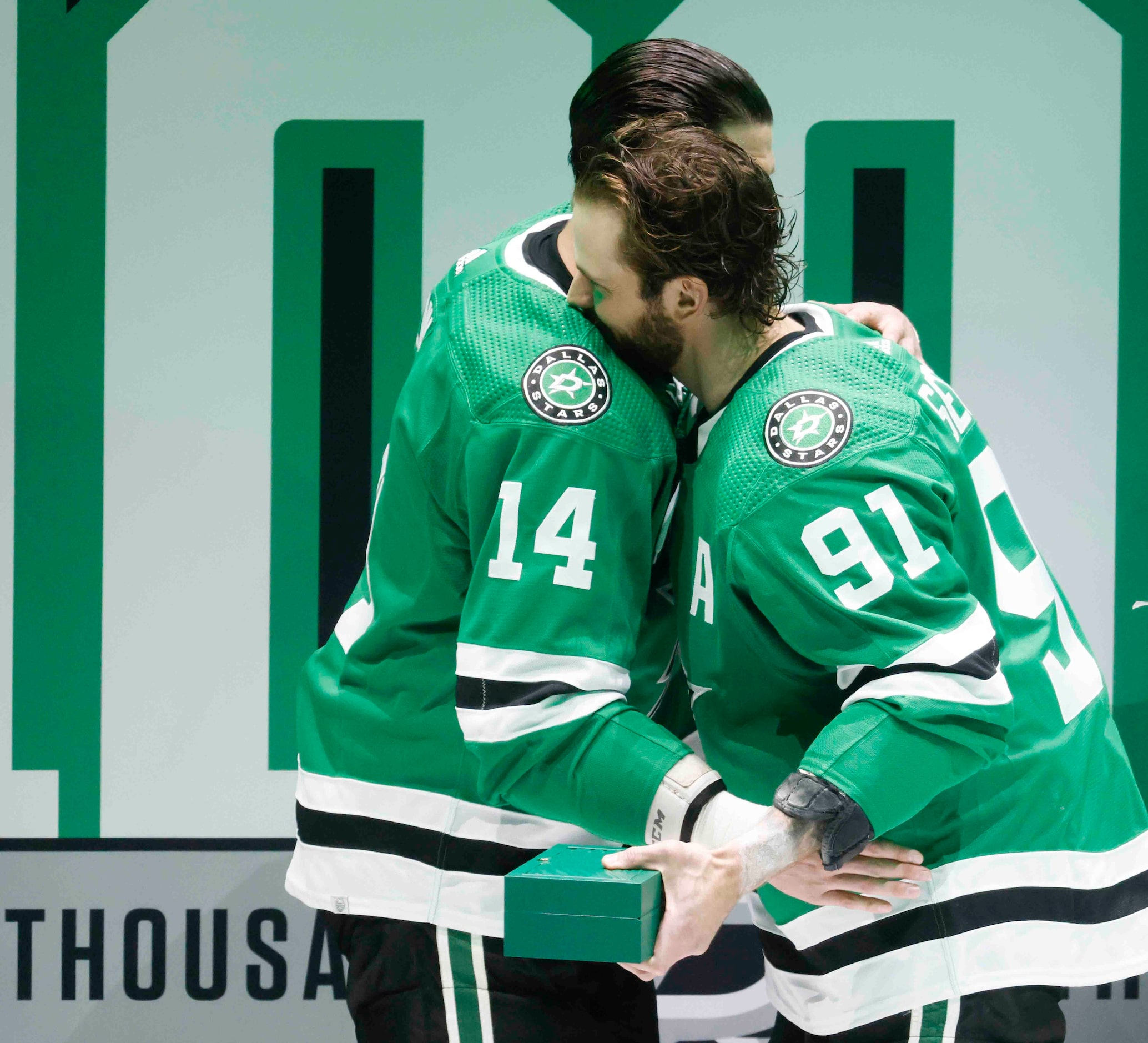 Dallas Stars left wing Jamie Benn (14) embraces center Tyler Seguin (91) during a ceremony...