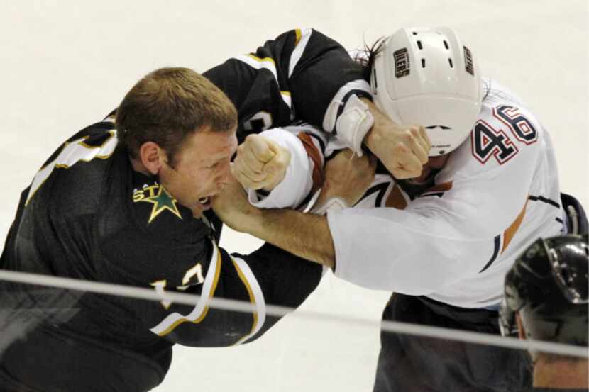 Dallas right wing Krys Barch (left) fiighs with Edmonton right wing Zack Stortini (46) fight...