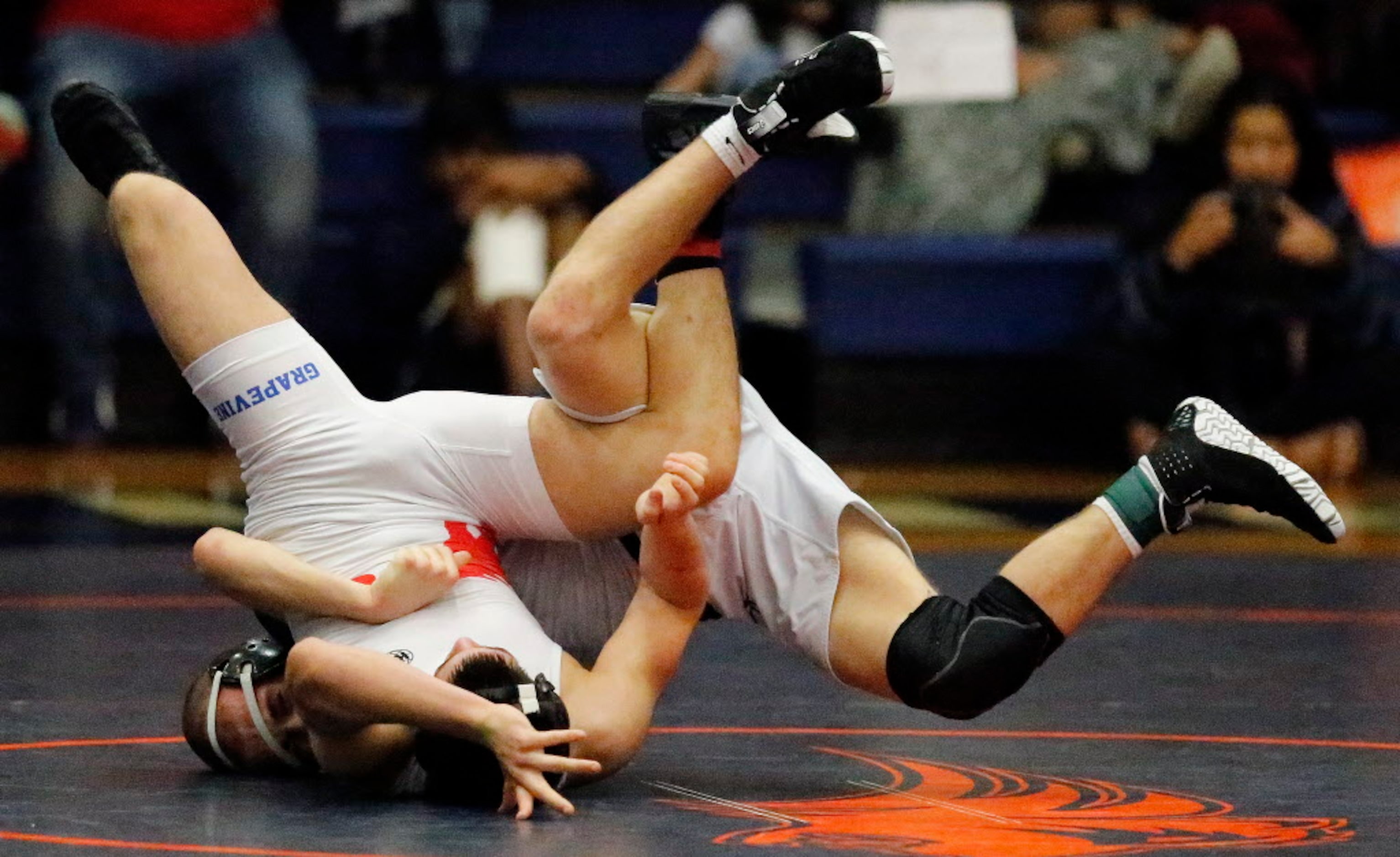 Tucker Spradley (rear) of Frisco Reedy High School, takes on Otto Rios of Grapevine High...