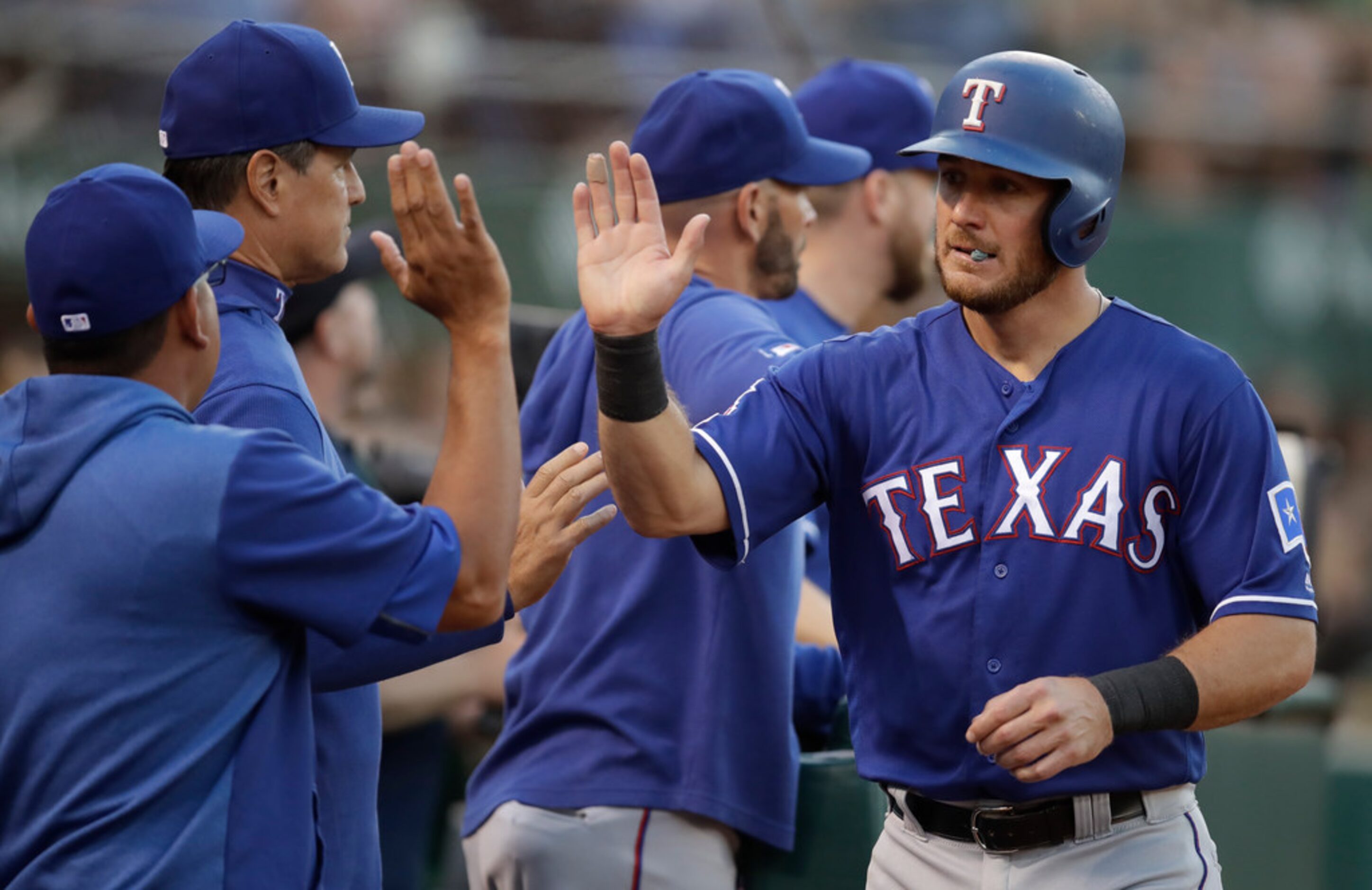 Texas Rangers' Jeff Mathis, right, is congratulated after scoring against the Oakland...