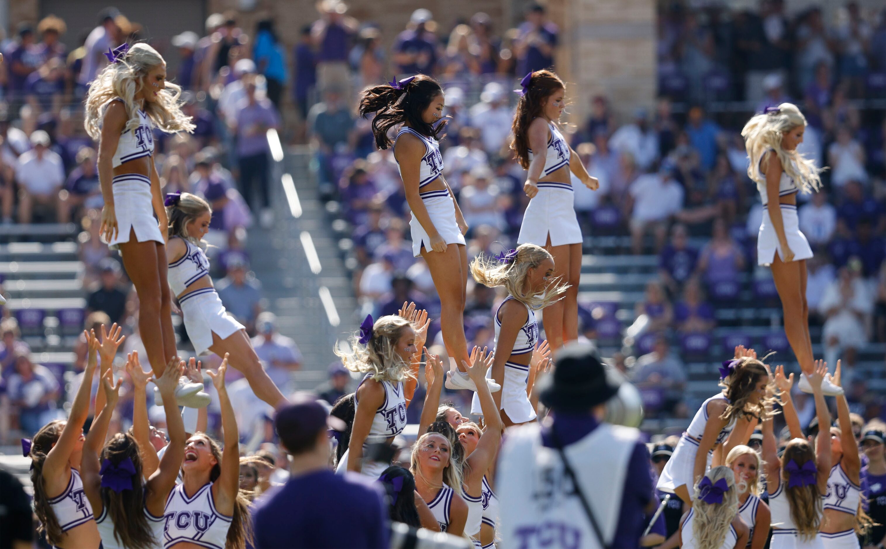 TCU cheerleaders perform during the first half of an NCAA college football game against the...