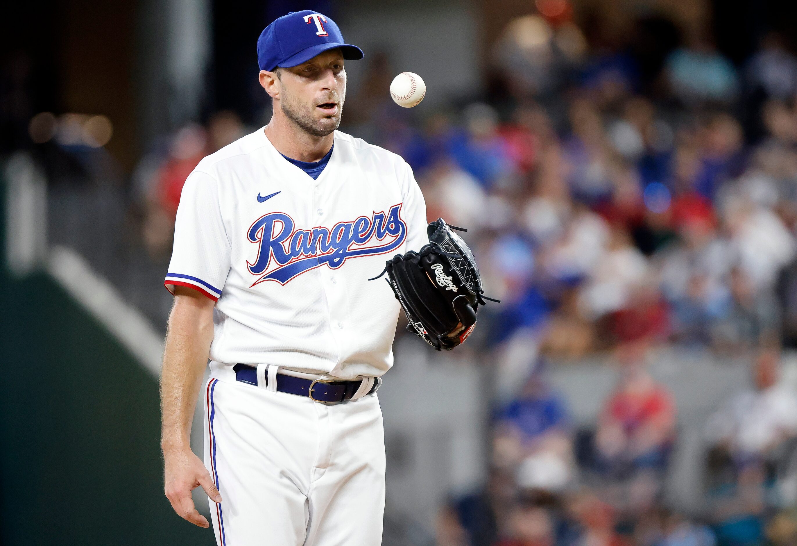 Texas Rangers starting pitcher Max Scherzer (31) tosses the ball out of his glove after...