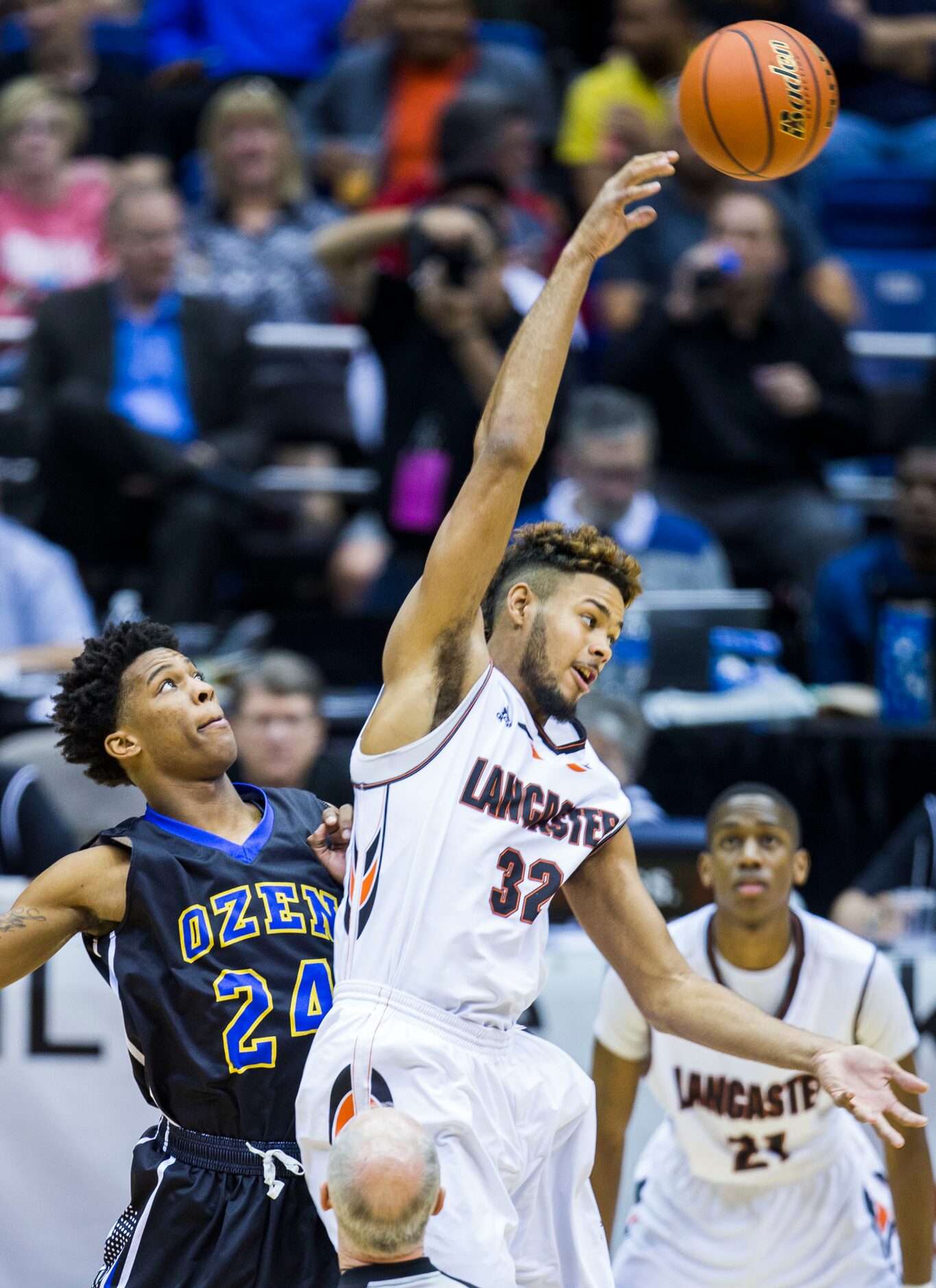 Lancaster forward/center Nate Morris (32) takes the tip-off from Beaumont Ozen forward...