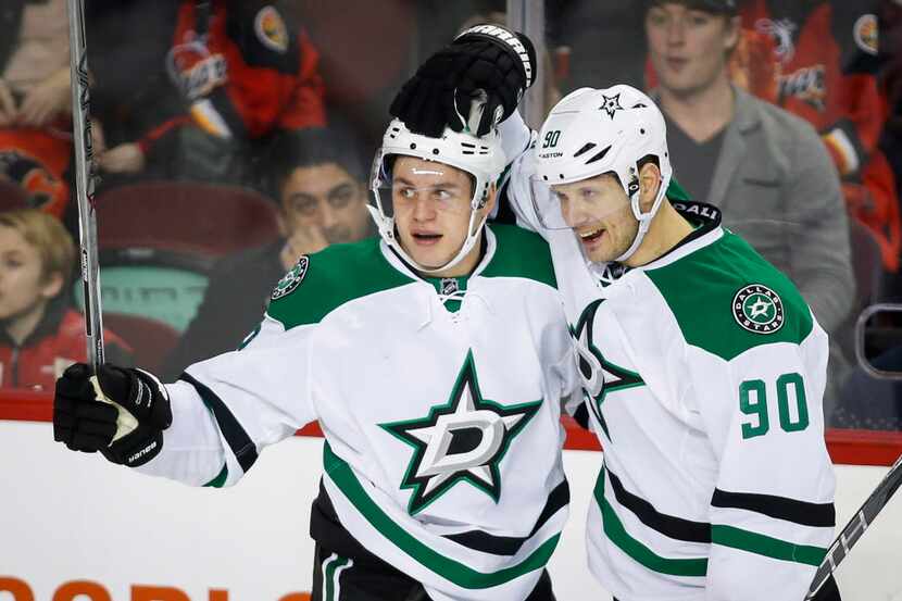 Dallas Stars' Mattias Janmark, left, of Sweden, celebrates his goal against the Calgary...