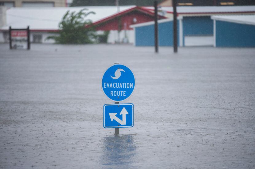 A hurricane evacuation route sign on Highway 96 hovered over floodwaters from Hurricane...