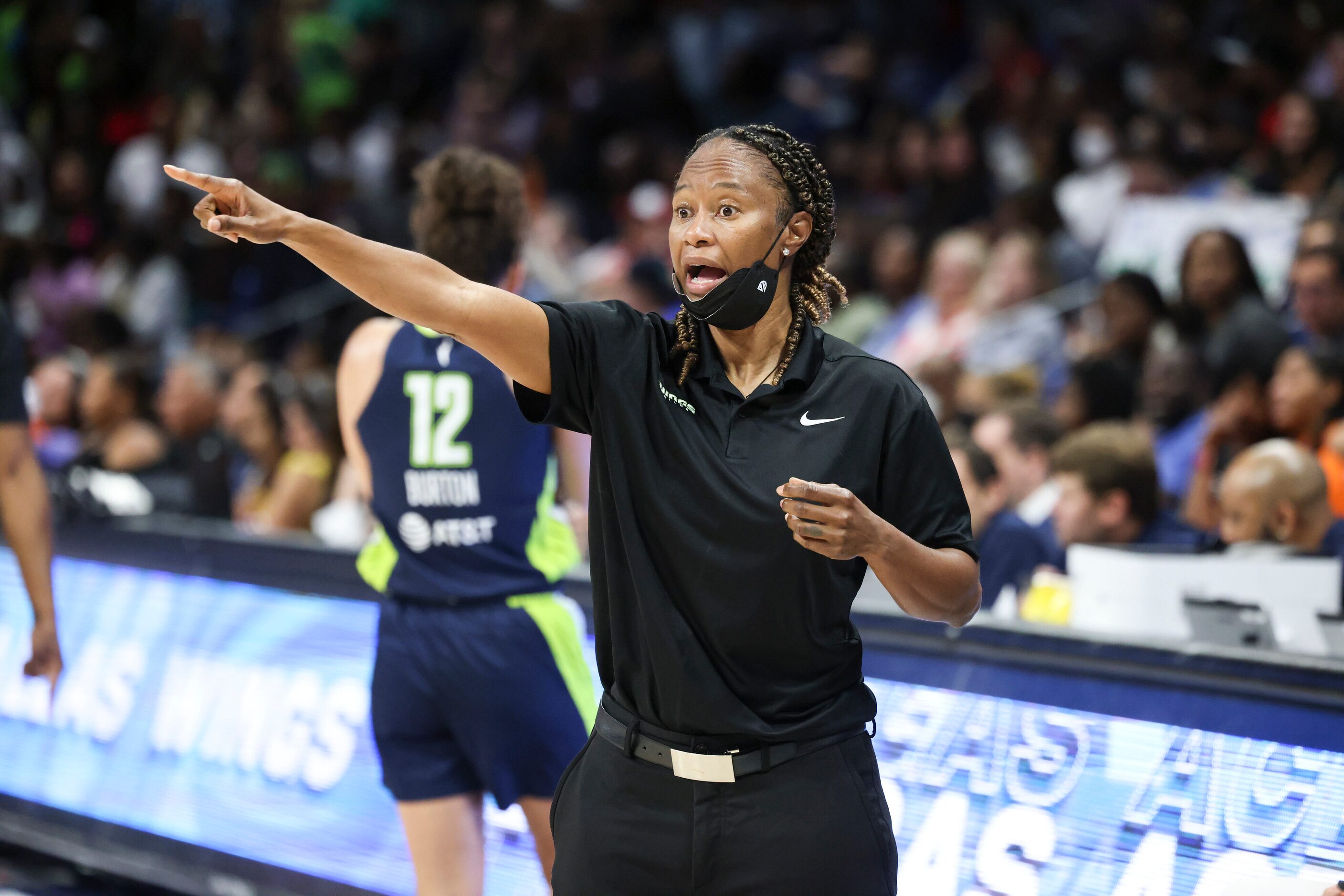 Vickie Johnson, Dallas Wings Head Coach, yells to players on the court in the game against...