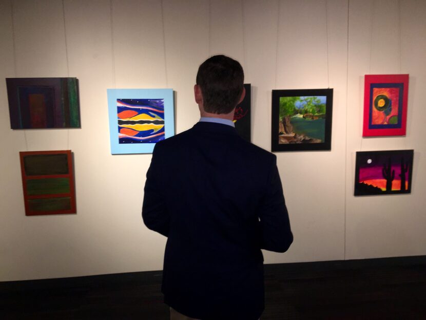 Dallas County Judge Clay Jenkins on Friday admired paintings at Dallas Love Field that were...