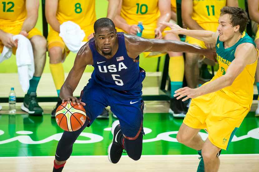 Kevin Durant (5) of the United States drives the ball around Ryan Broekhoff (9) of Australia...
