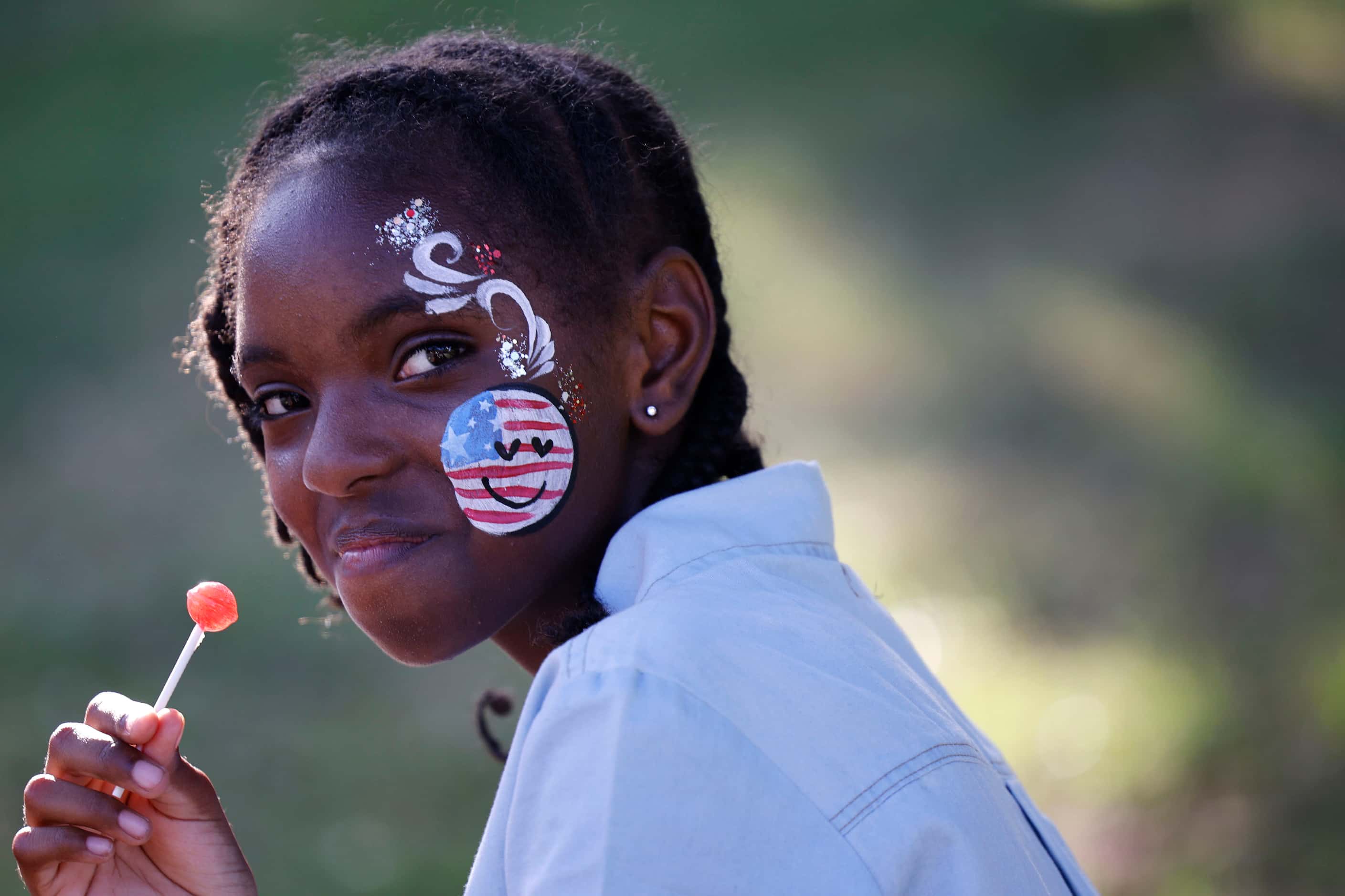 Angel Young, 11, of Dallas with a face painting is seen during the Fair Park Fourth...