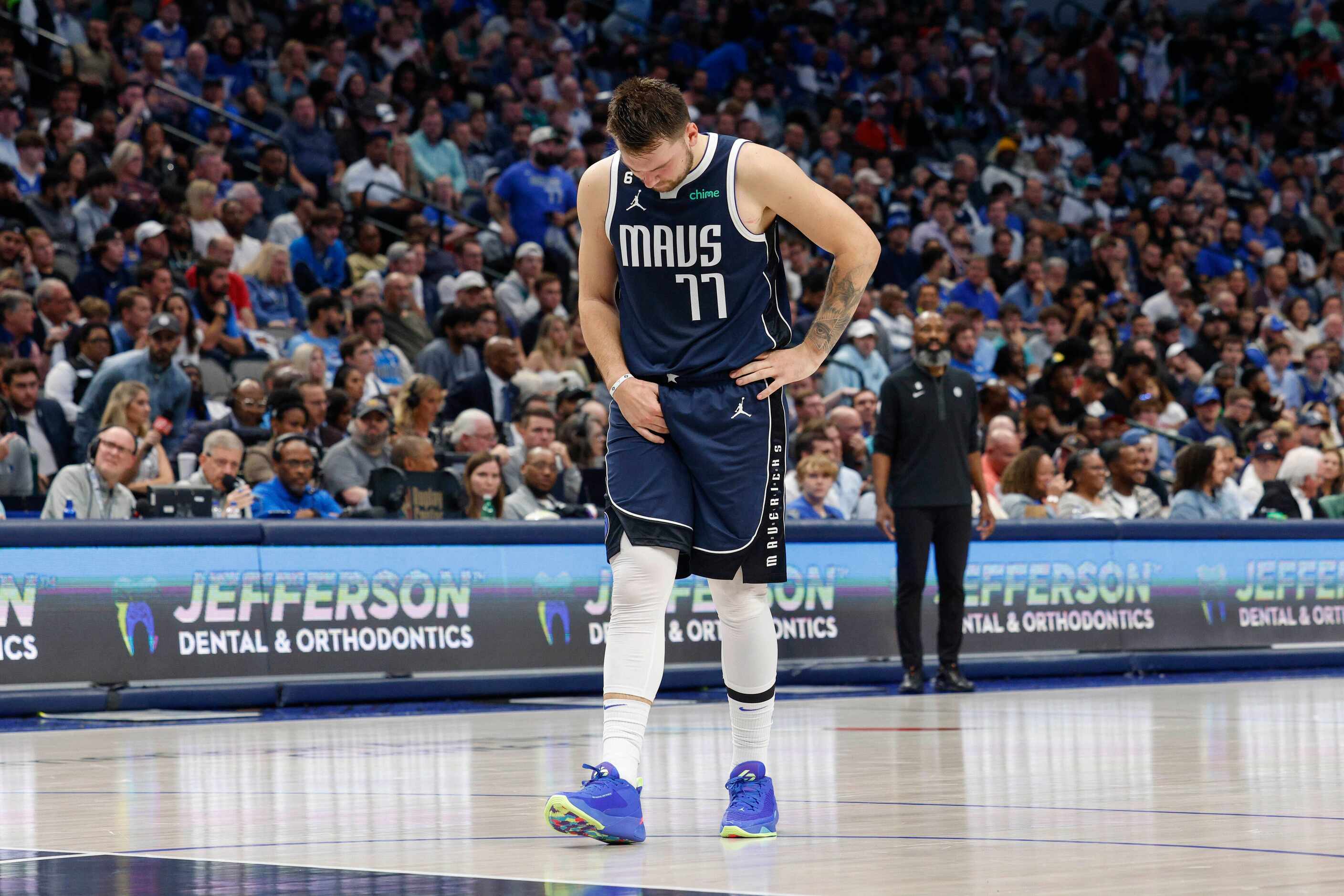 Dallas Mavericks guard Luka Doncic (77) grabs his groin after slipping on the court during...