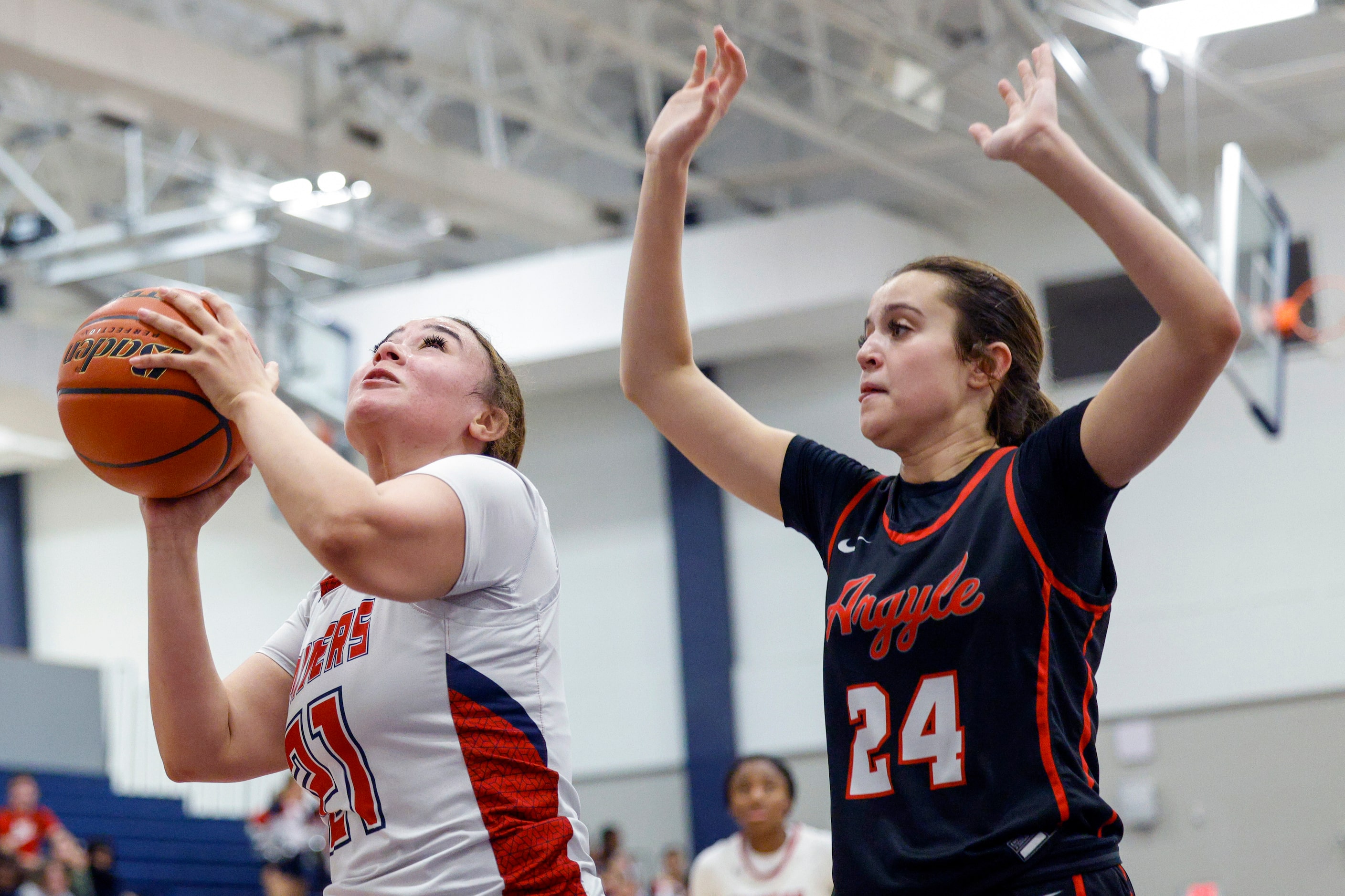 Denton Ryan center Aspen Hicks (21) drives to the basket against Argyle guard Brooklyn...