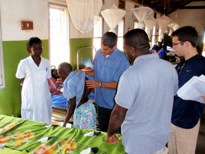 Dr. Isador Lieberman examined a patient at Mulago Hospital in Kampala, Uganda, during the...