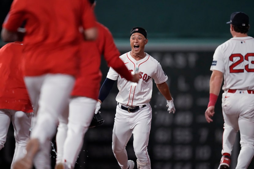 Boston Red Sox's Rob Refsnyder, center, celebrates after his winning RBI single in the 10th...