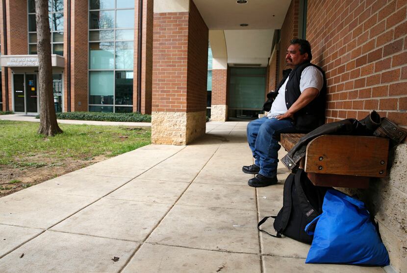 Pedro Garza of McKinney sits on a bench outside of the Roy and Helen Hall Public Library in...