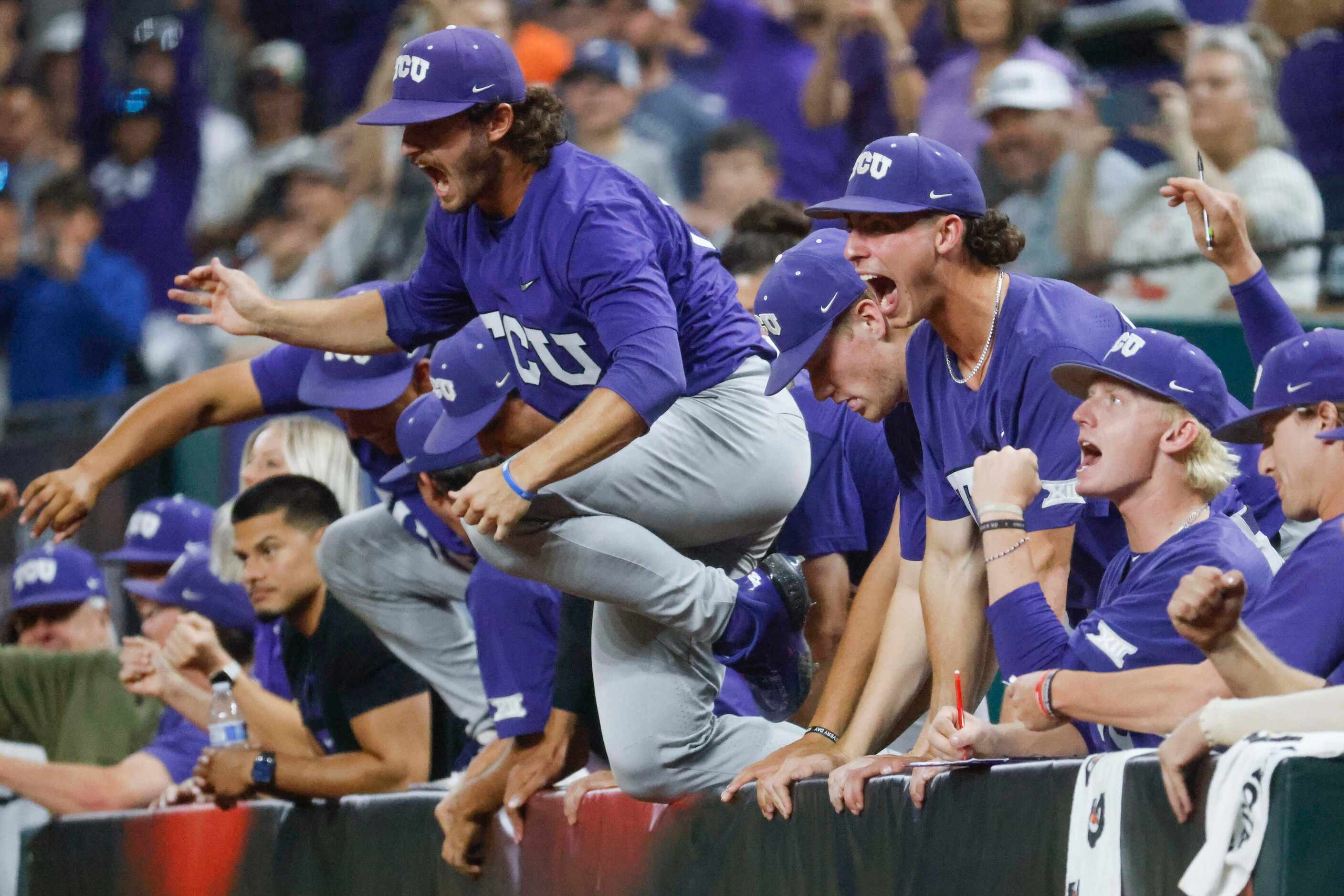 TCU players rush out of the dugout after winning the Big 12 baseball championship game...