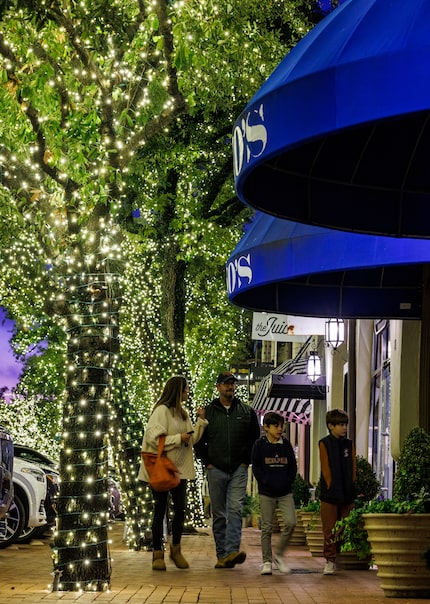 A crew spends 50 days stringing the white lights around trees in Highland Park Village. If...