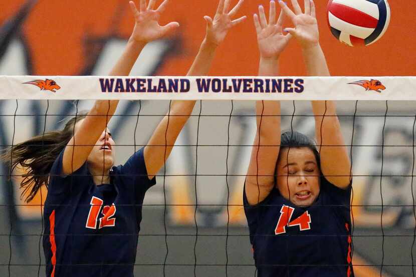 Frisco Wakeland middle blocker Izzy West (12) and right side Vivian Osborn (14) attempt a...