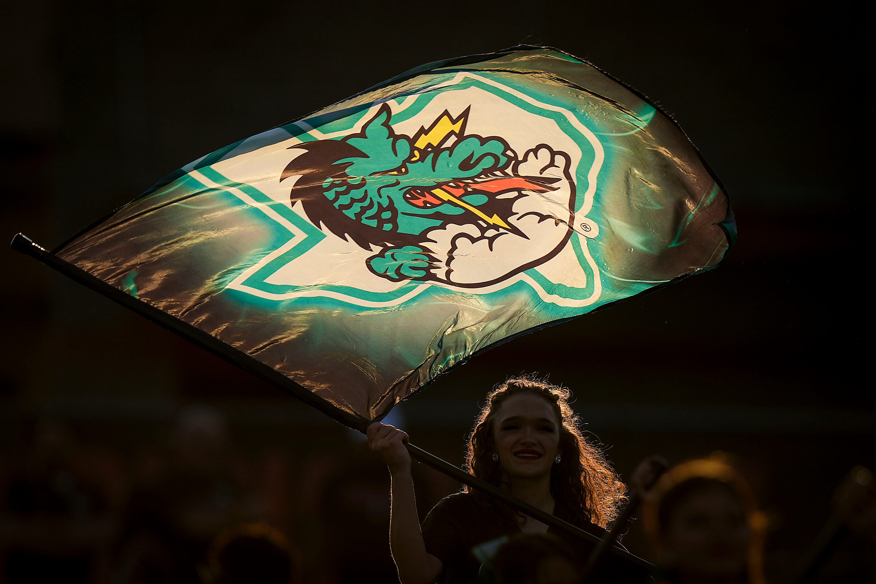 Members of the Southlake Carroll color guard perform before a high school football game...