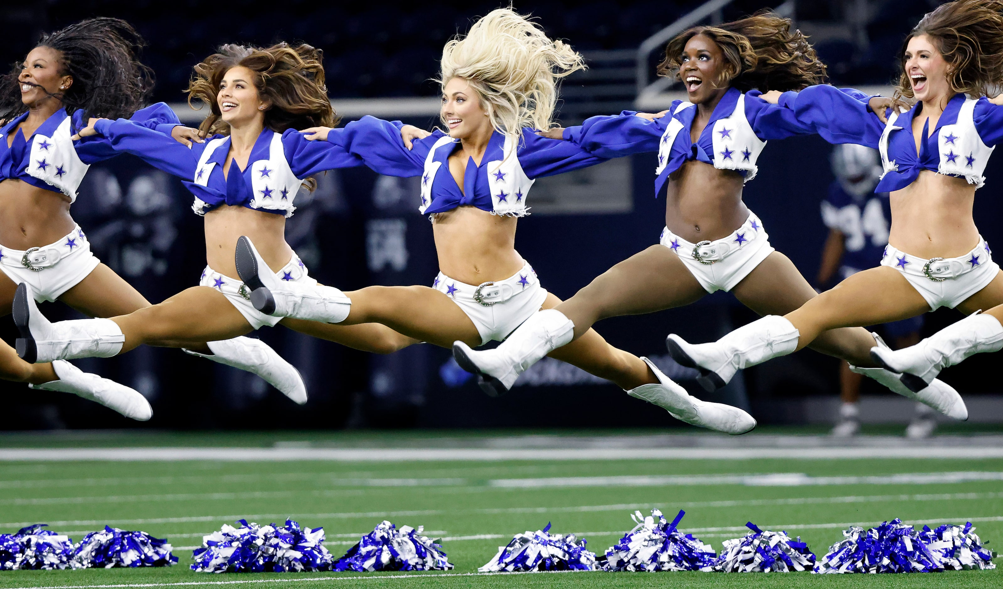 The Dallas Cowboys Cheerleaders jump into the splits at the end of their Season Kickoff...