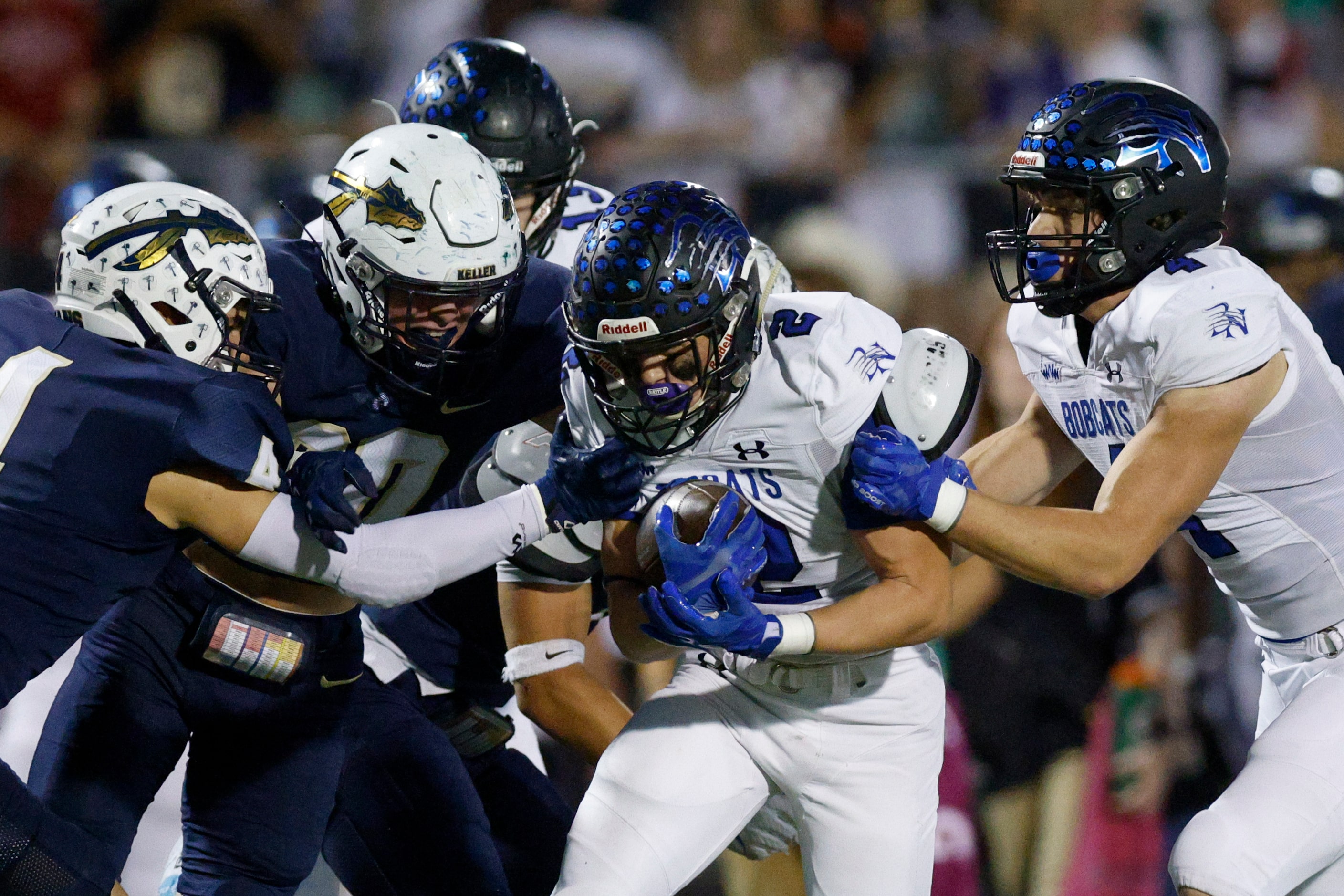 Keller defensive backs Eli Brinton (4) and Jay Powitz (20) tackle Trophy Club Byron Nelson...