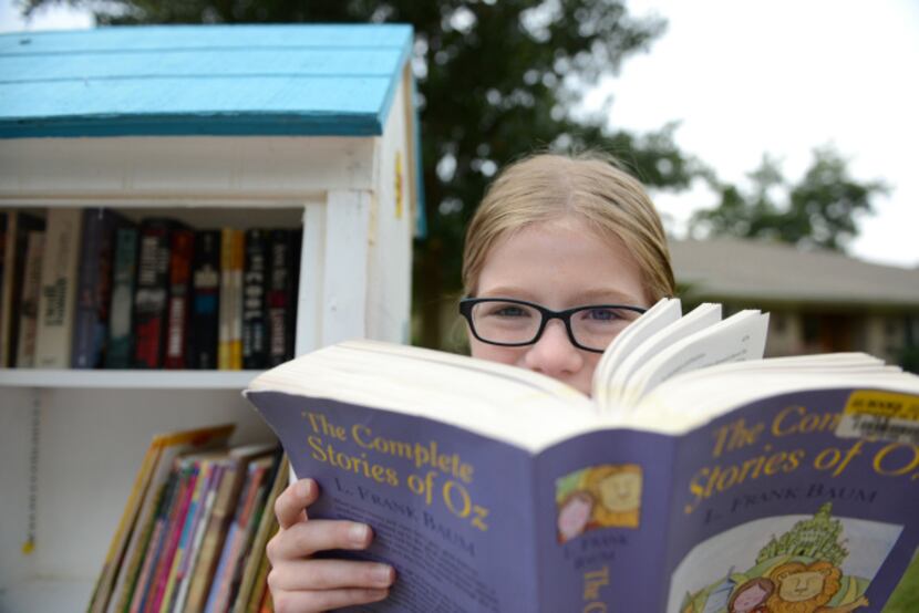 Hannah Wahl, 11, is the steward of her Little Free Library on Malcolm Drive in Lakewood. The...