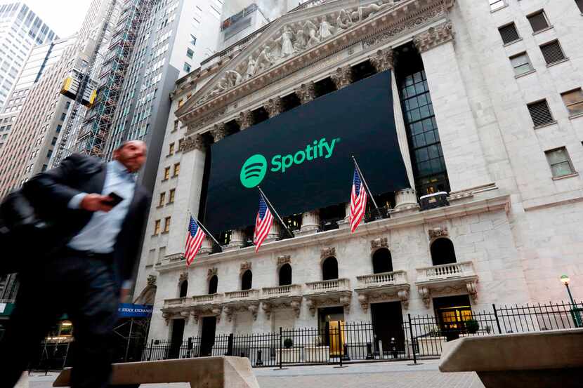 In this April 3, 2018, file photo, a Spotify banner adorns the facade of the New York Stock...