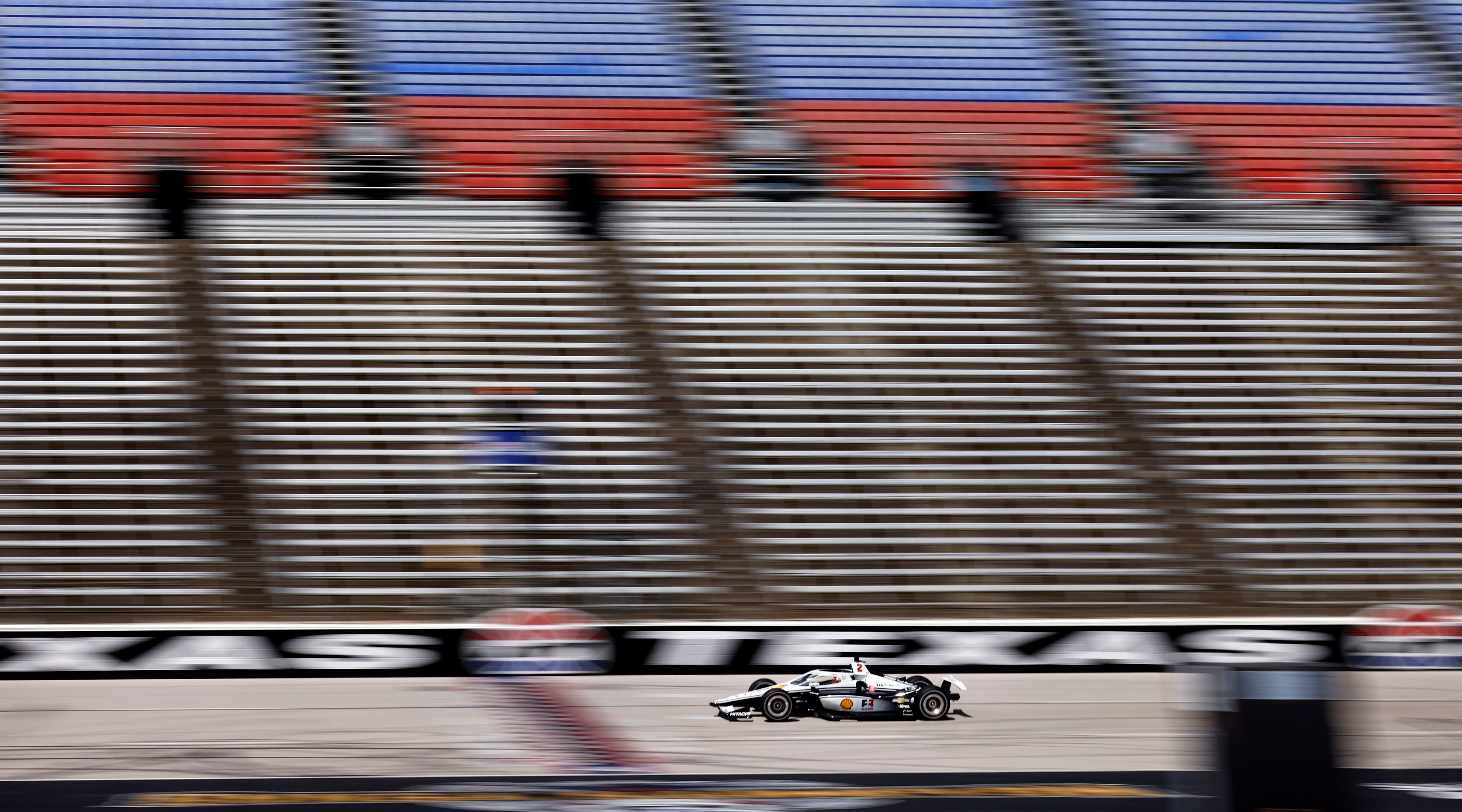 Indy Car driver Josef Newgarden speeds down the front stretch as he practices for the...