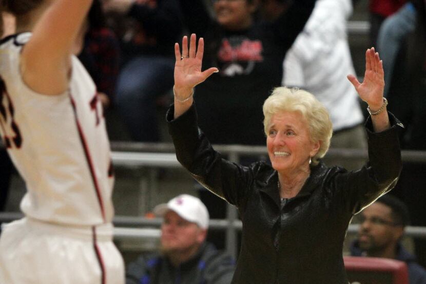 Euless Trinity head coach Sue Cannon celebrates with her team following their come-from...