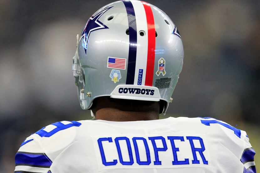 Dallas Cowboys wide receiver Amari Cooper (19) sports a helmet with red, white and blue...