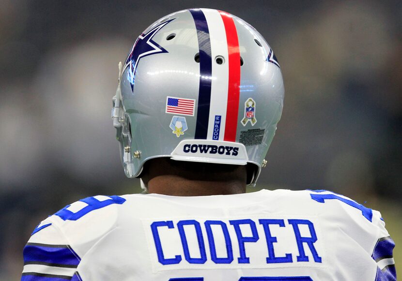 Dallas Cowboys wide receiver Amari Cooper (19) sports a helmet with red, white and blue...