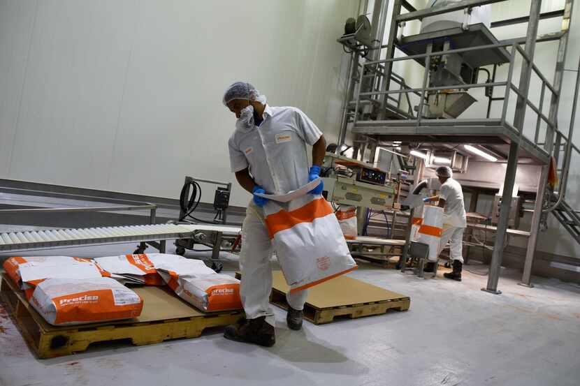 Packaging operators Steven Gallego (left) and Xavier Meza packed beef topping seasoning at a...