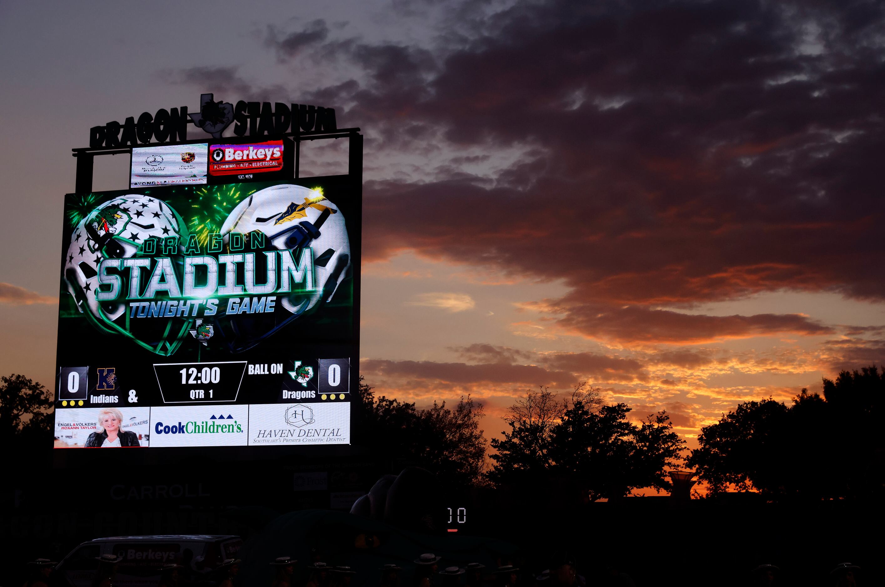 The suns sets behind the Southlake Carroll scoreboard before the Keller football game at...