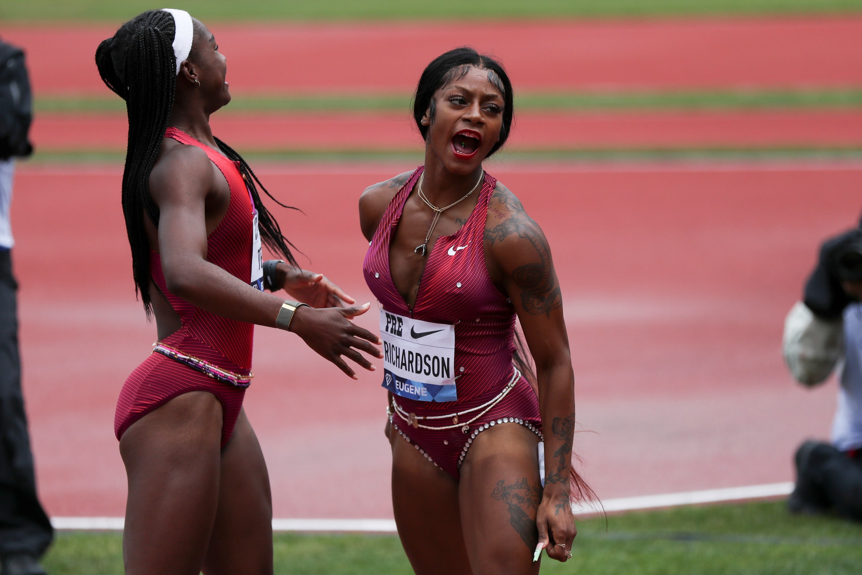 United States' Sha'Carri Richardson, right, celebrates her second-place finish in the...