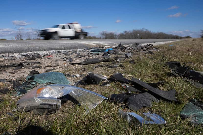 Drivers pass the debris, where six people, including two children, died and three others...