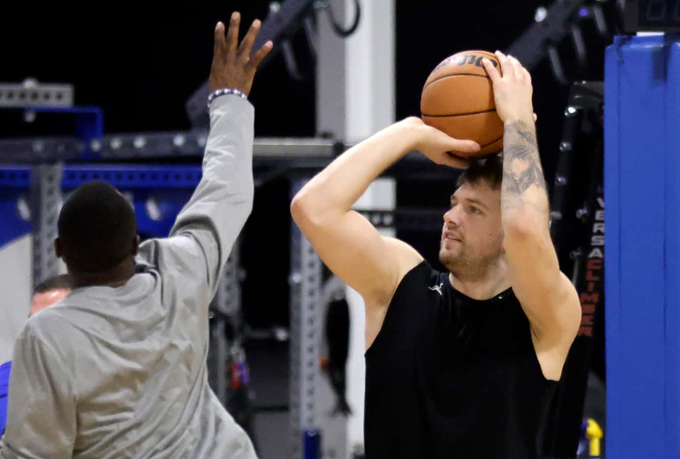Dallas Mavericks guards Luka Doncic (right) practiced shooting 3-pinters at their practice...